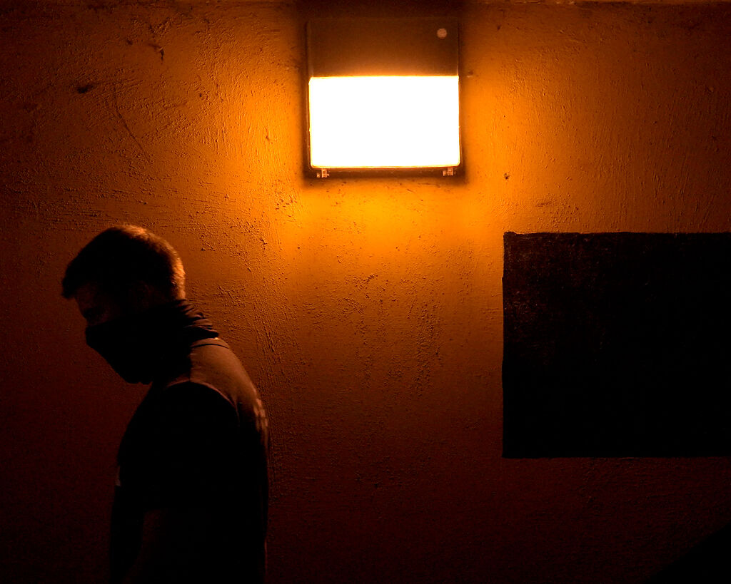 A protester walks through the tunnel under Stadium Blvd. towards Memorial Stadium during